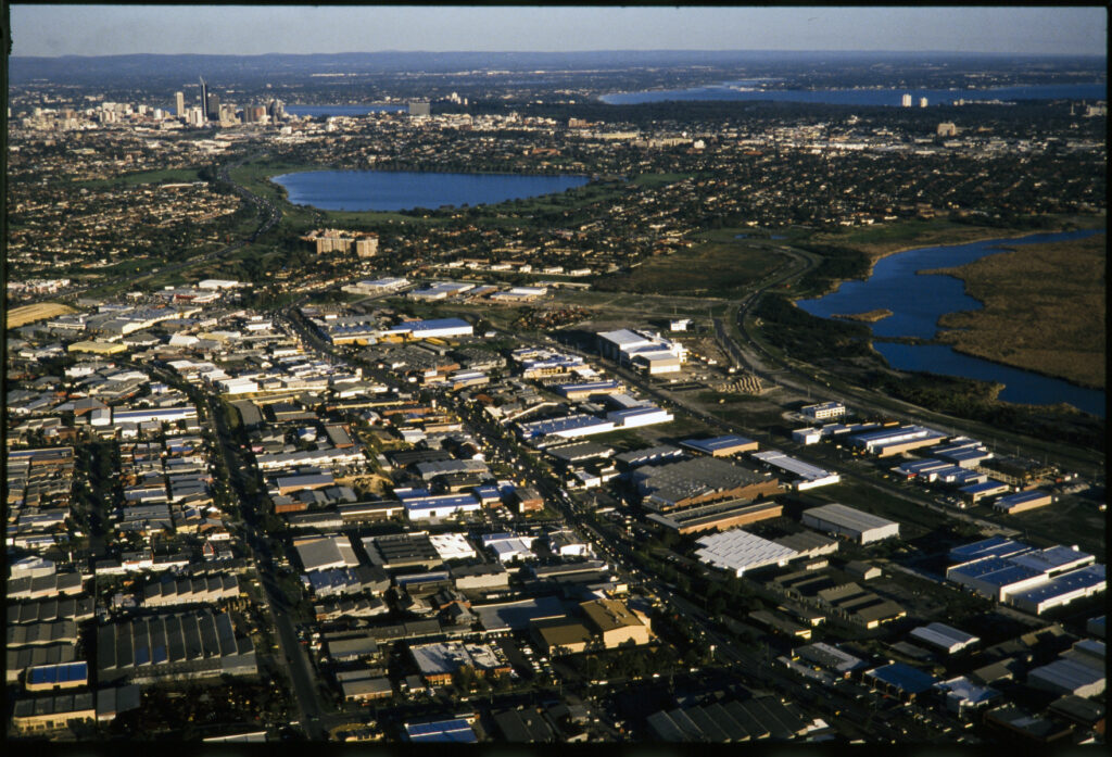 Aerial of industrial area in Osborne Park with Perth in background c1988